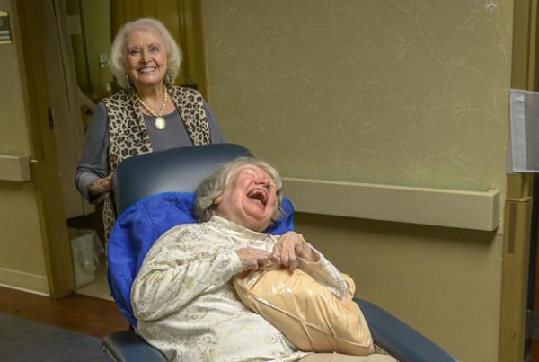 an elderly woman in a reclining chair with her mouth open