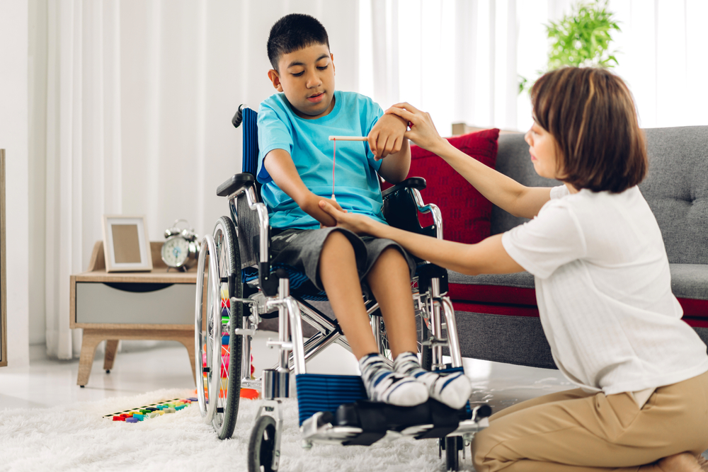 a woman helping a boy in a wheelchair