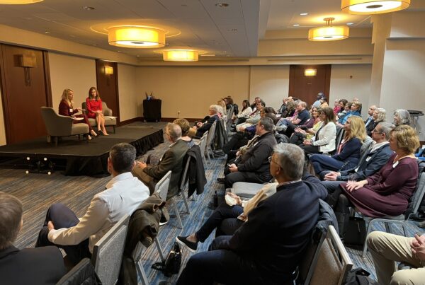 a group of people sitting in chairs in a room