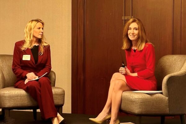 two women sitting in chairs talking to each other