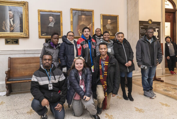 a group of people posing for a picture in a museum