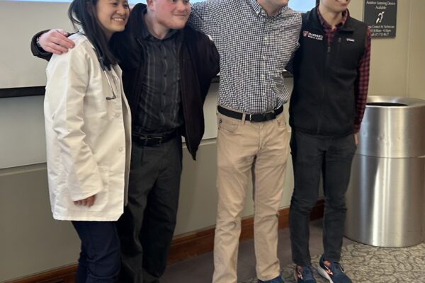 a group of people standing in front of a projector screen