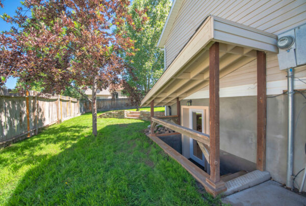 a back yard with a fence and trees