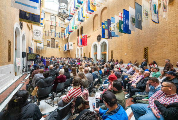 a large group of people sitting in chairs in a building