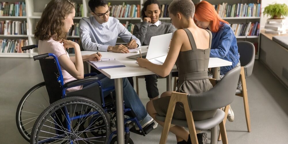 a group of people sitting around a table in a library