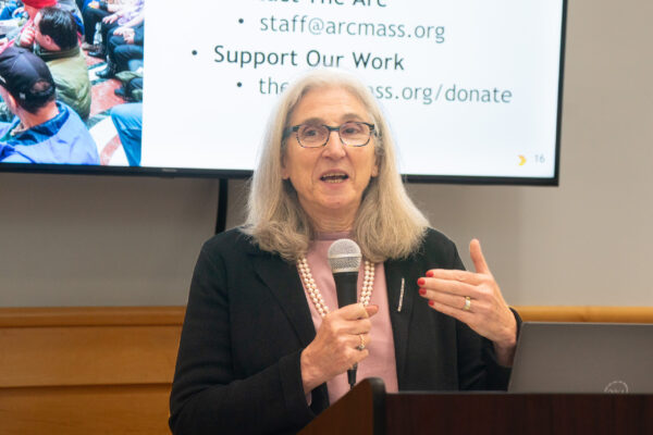 a woman standing at a podium with a microphone