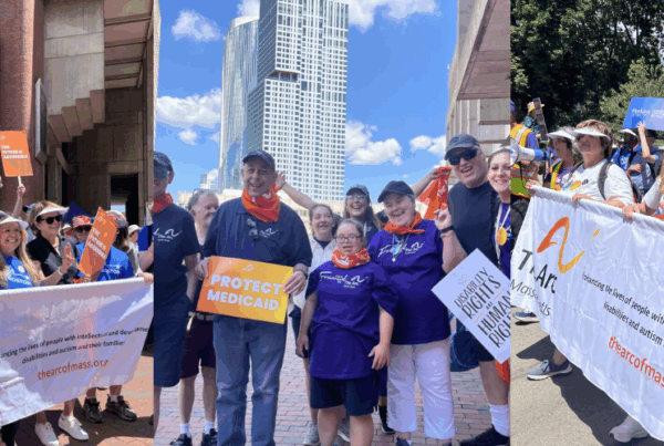 a group of people holding up signs in front of a building