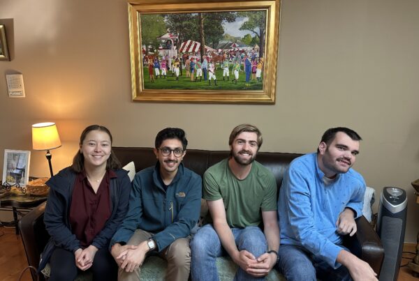 a group of people sitting on a couch in a living room