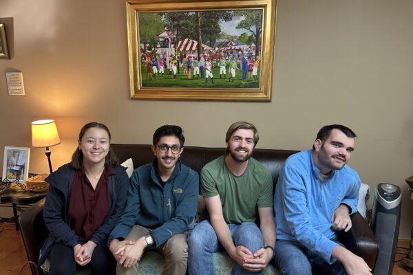 a group of people sitting on a couch in a living room