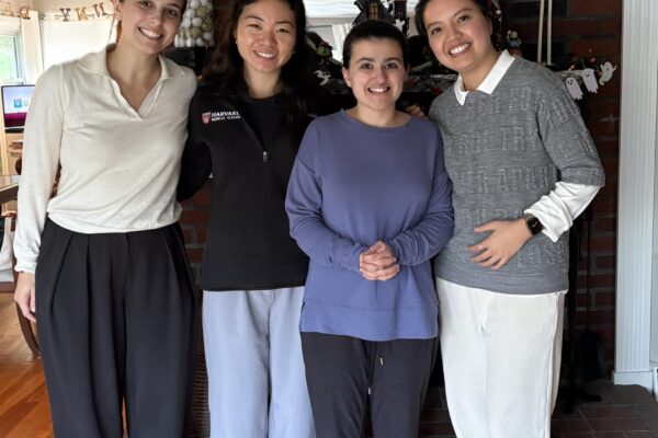 a group of women standing next to each other on a hard wood floor