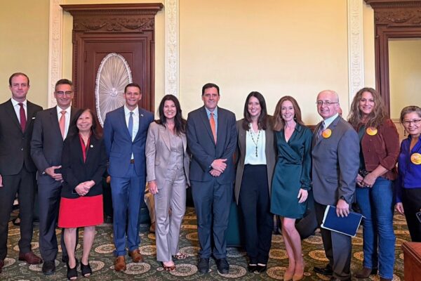 a group of people standing next to each other in a room
