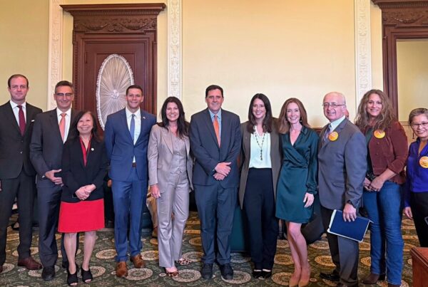 a group of people standing next to each other in a room