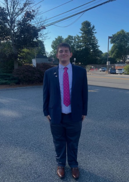 a man in a suit and tie standing in the street