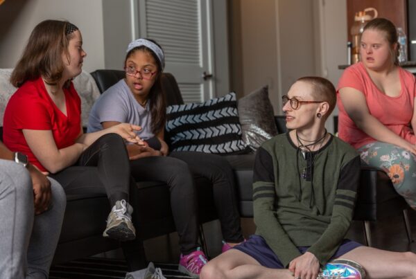 a group of people sitting around a living room