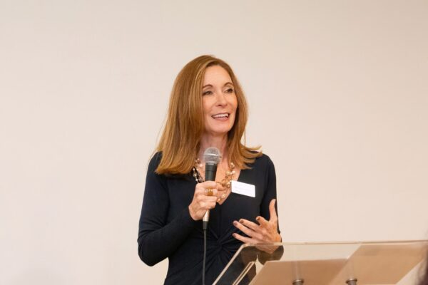 a woman standing at a podium with a microphone