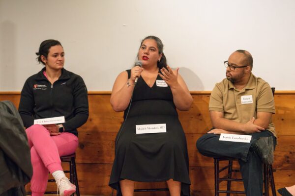 a group of people sitting in front of a whiteboard