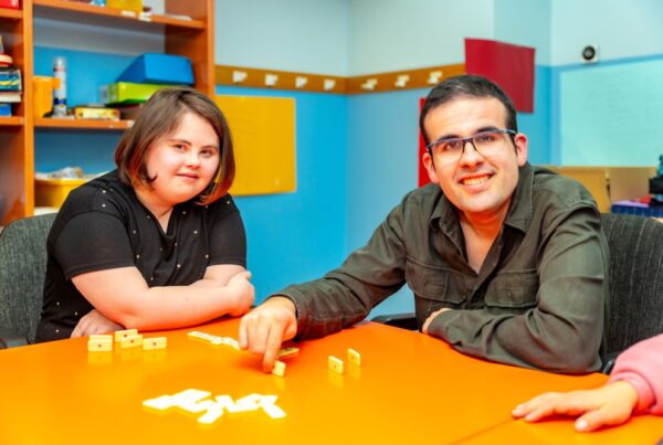 a man and a woman sitting at a table playing a game
