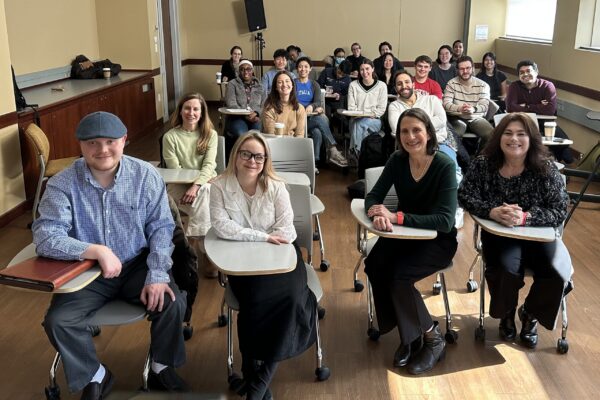 a group of people sitting in chairs in a room