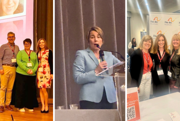 a group of people standing in front of a screen