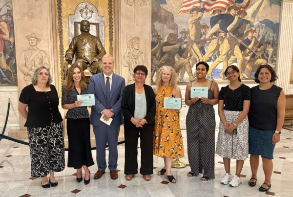 a group of people standing in front of a statue