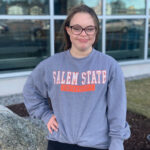 A young woman wearing a Salem State sweatshirt