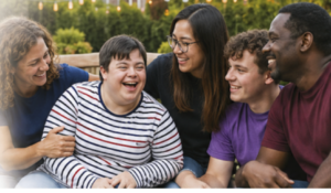 Five people looking and smiling at each other