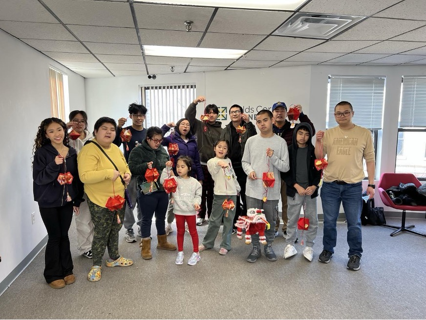 Members of the Circle of Vietnamese Parents holding up Lunar New Year crafts
